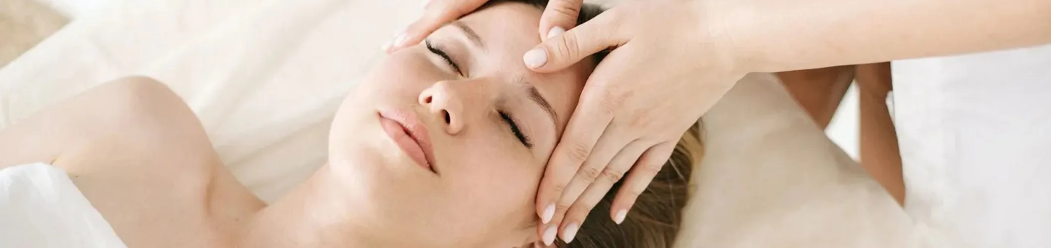 A woman getting her face washed by a masseuse.